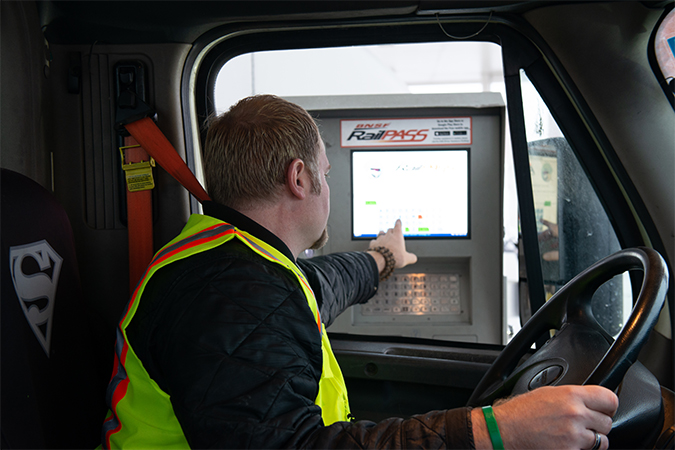 A truck driver uses a kiosk at the entrance to a BNSF intermodal facility. 